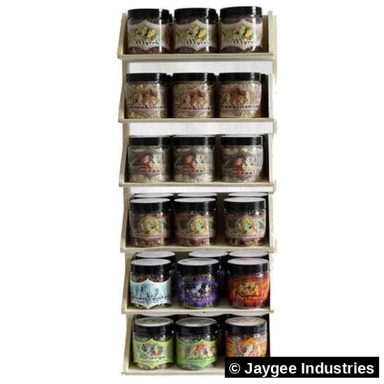Mystic Sutra resin jars on a wooden shelf display at a wellness store