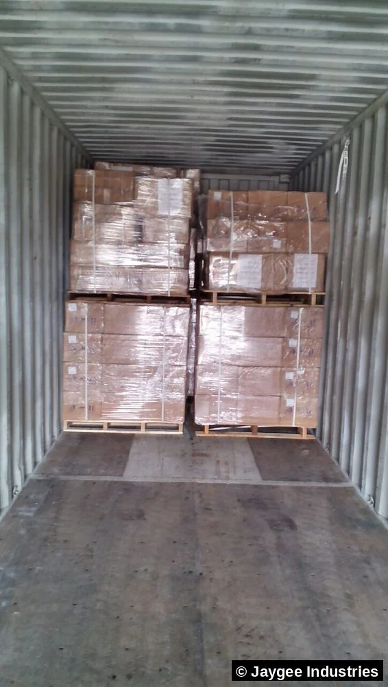Four shrink-wrapped pallets of incense cartons neatly loaded inside a shipping container